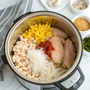 Instant Pot filled with beans, corn, and chicken for chili