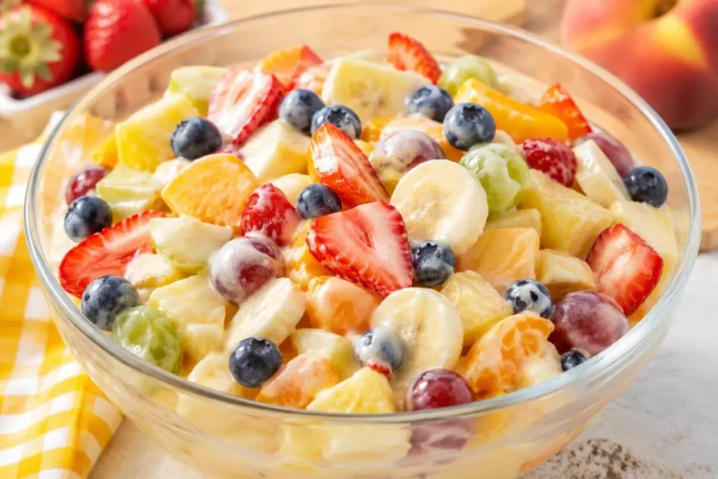 fruit salad with vanilla pudding in a glass serving bowl