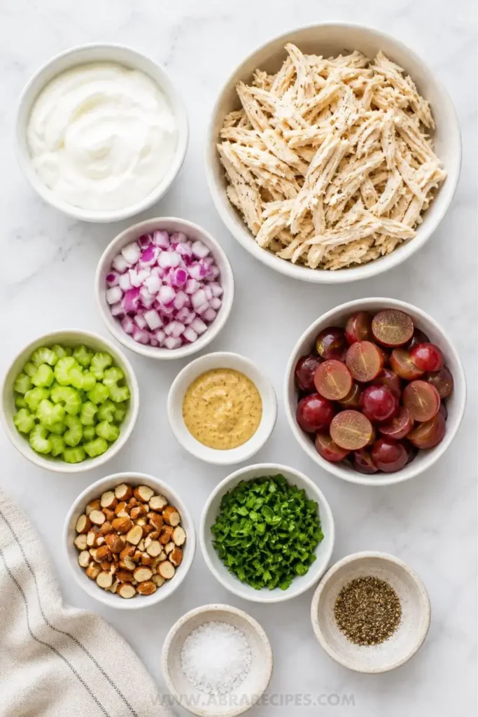Ingredients for Greek yogurt chicken salad including chicken grapes celery and Greek yogurt