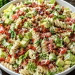 BLT pasta salad with beef bacon, rotini, tomatoes, avocado, and ranch dressing in a large white bowl