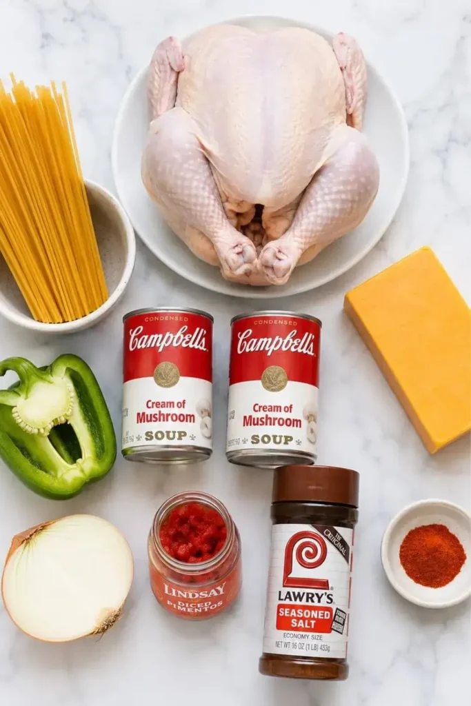 All ingredients for chicken spaghetti recipe laid out on a marble surface